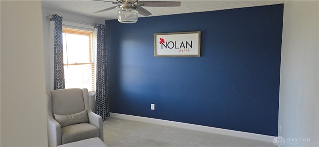 sitting room featuring carpet flooring and ceiling fan