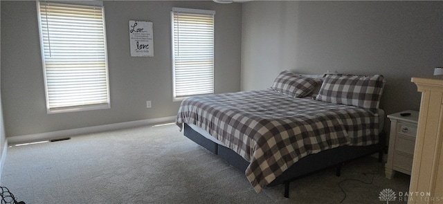 carpeted bedroom featuring multiple windows