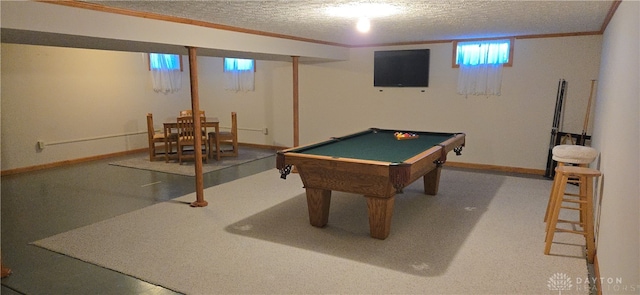 game room with pool table, crown molding, and a textured ceiling