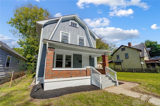 front facade featuring a front lawn and covered porch