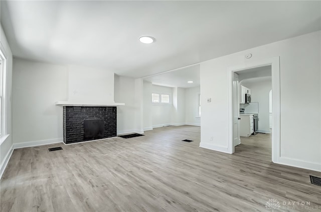 unfurnished living room with light hardwood / wood-style floors and a fireplace