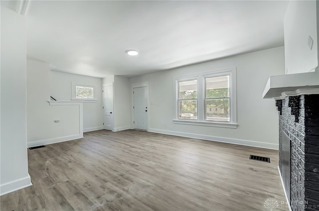 unfurnished living room featuring light wood-type flooring