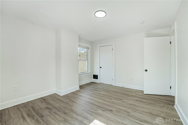 unfurnished room with light hardwood / wood-style floors