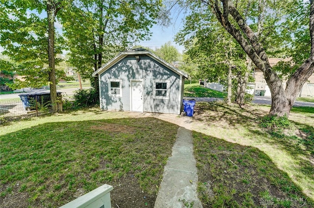 view of outdoor structure featuring a lawn