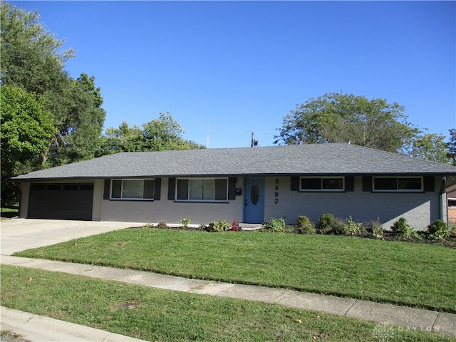 single story home featuring a garage and a front yard