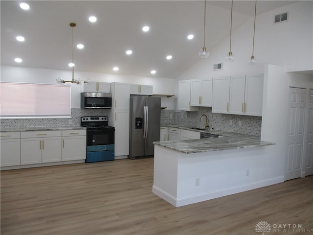 kitchen featuring decorative light fixtures, stainless steel appliances, kitchen peninsula, and white cabinetry