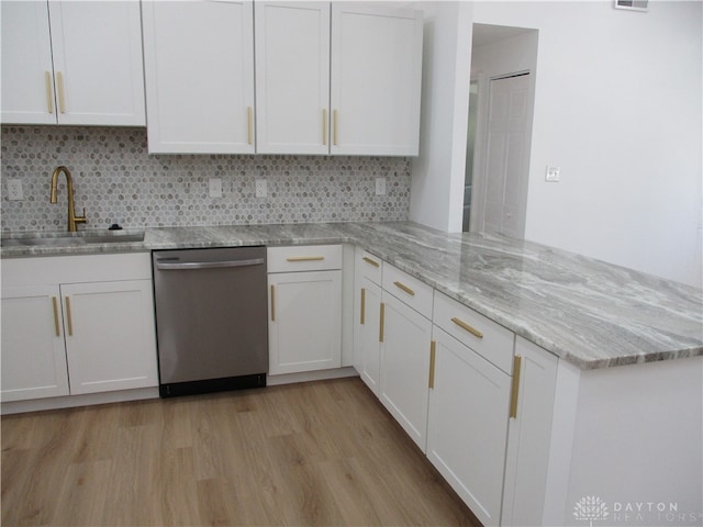 kitchen with dishwasher, light hardwood / wood-style floors, light stone counters, sink, and white cabinets