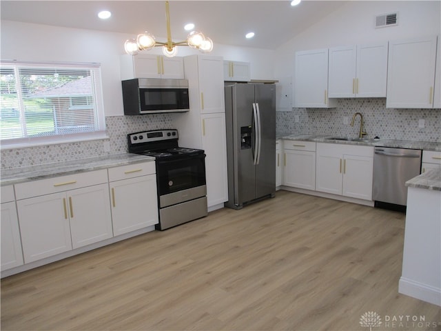 kitchen with light hardwood / wood-style flooring, stainless steel appliances, backsplash, and sink