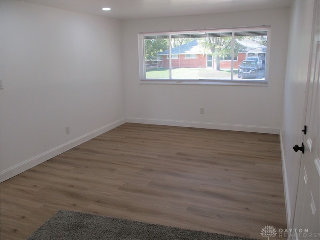 unfurnished room with dark hardwood / wood-style flooring and a wealth of natural light