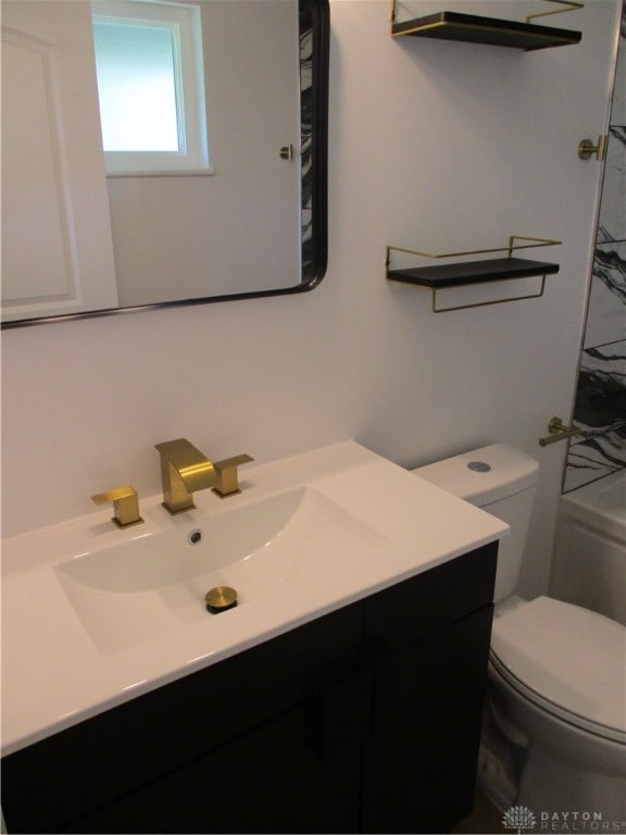 bathroom featuring vanity and toilet