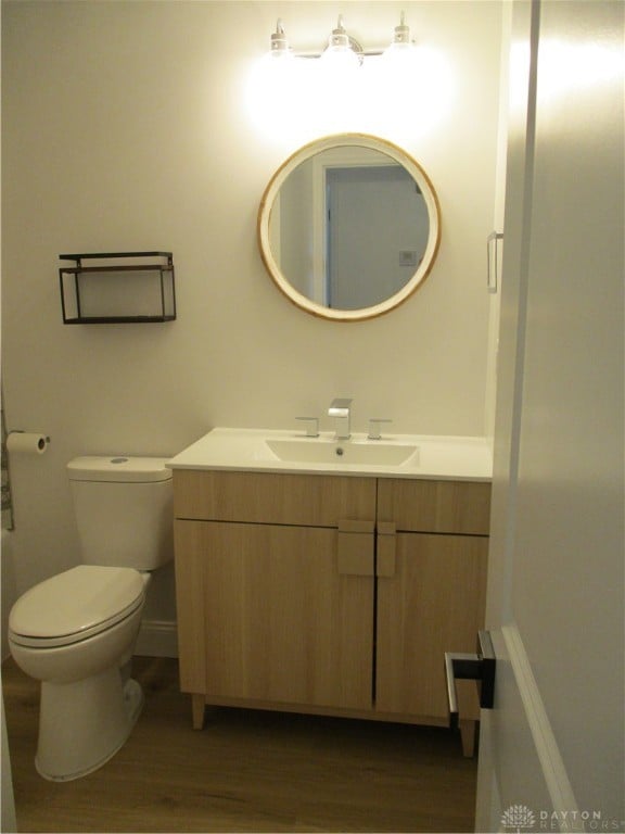 bathroom featuring hardwood / wood-style floors, vanity, and toilet