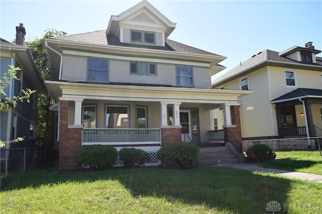 view of front of property with covered porch and a front yard