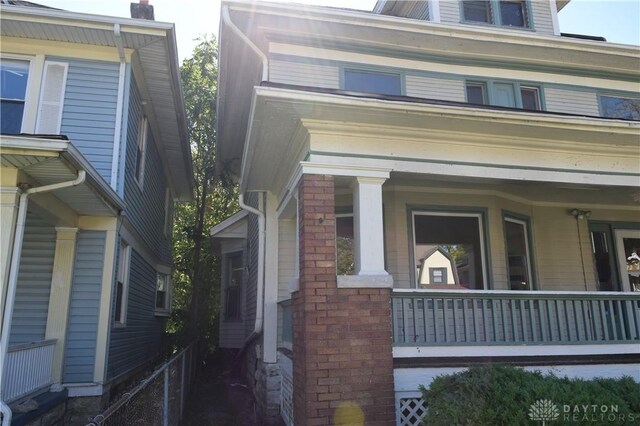 view of property exterior featuring covered porch