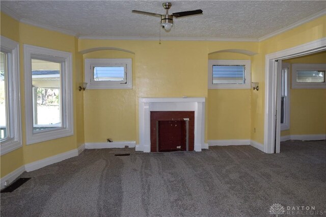 unfurnished living room with ceiling fan, crown molding, carpet, and a textured ceiling