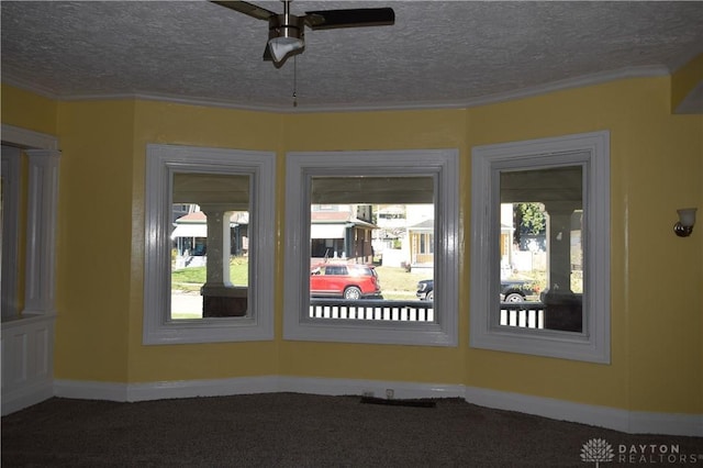 unfurnished sunroom with ceiling fan