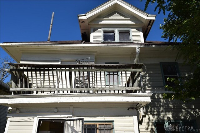 back of house featuring a balcony