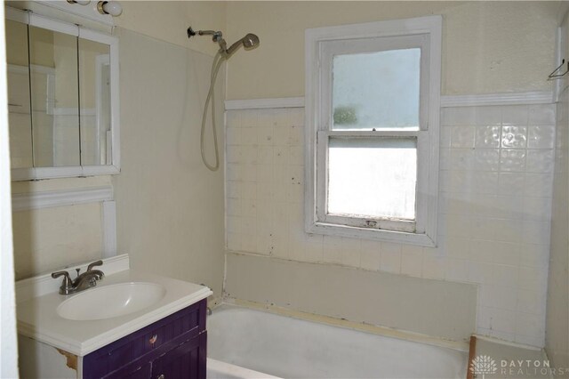 bathroom featuring vanity and washtub / shower combination