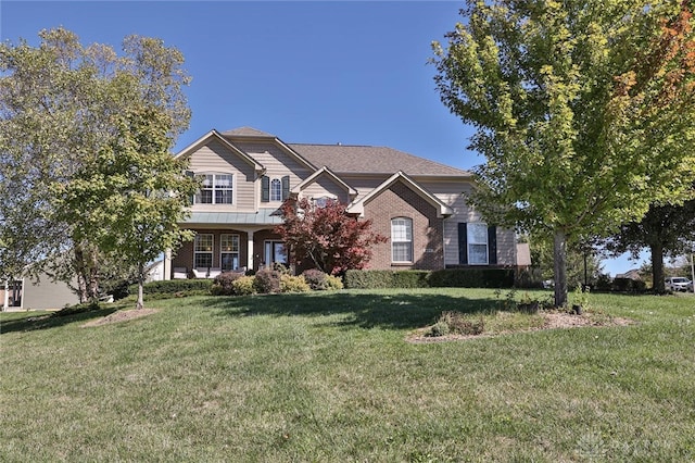 view of front facade with a front lawn and covered porch