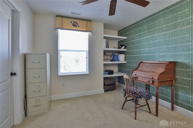 miscellaneous room with a textured ceiling, light colored carpet, and ceiling fan