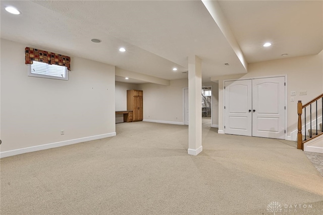 basement featuring light carpet