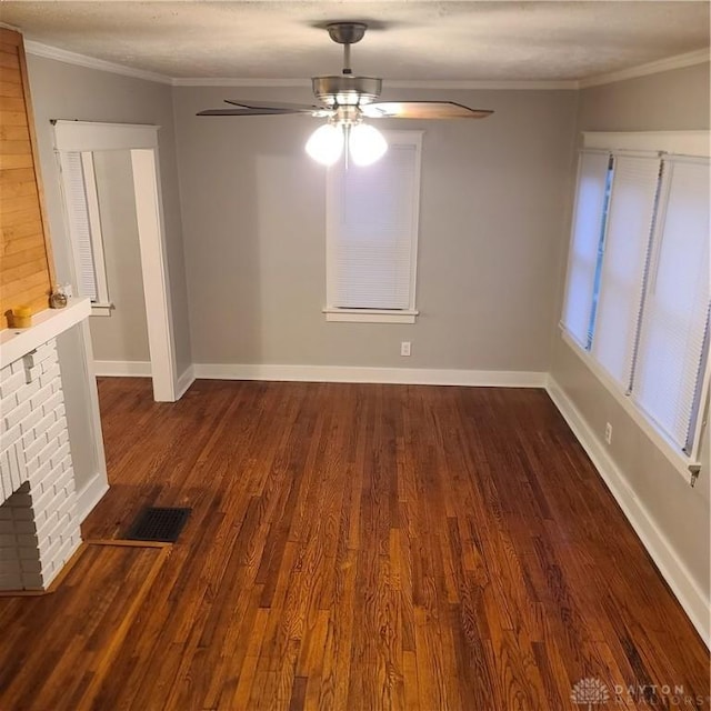 unfurnished living room with a fireplace, dark hardwood / wood-style floors, ceiling fan, and ornamental molding