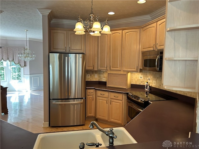 kitchen with pendant lighting, a notable chandelier, stainless steel appliances, and light wood-type flooring