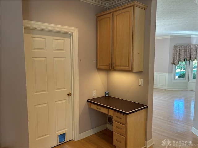 unfurnished office featuring crown molding, light hardwood / wood-style floors, and a textured ceiling