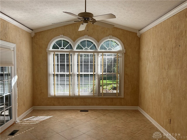 spare room with lofted ceiling, crown molding, ceiling fan, and a textured ceiling