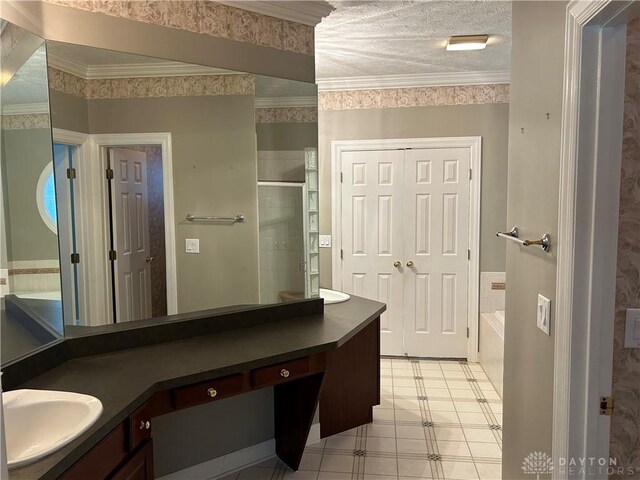 bathroom with a textured ceiling, ornamental molding, vanity, and independent shower and bath