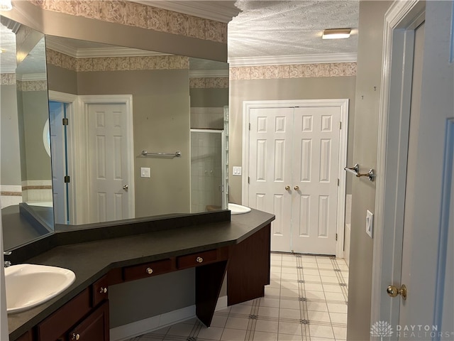 bathroom featuring walk in shower, crown molding, vanity, and a textured ceiling