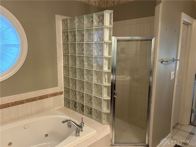 bathroom featuring shower with separate bathtub and tile patterned flooring