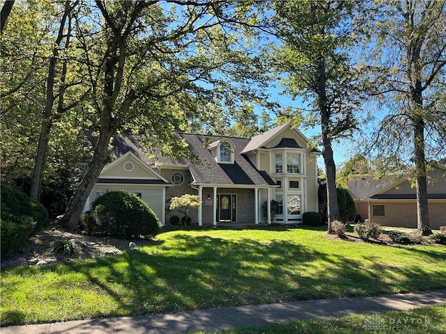 view of front of property with a garage and a front yard