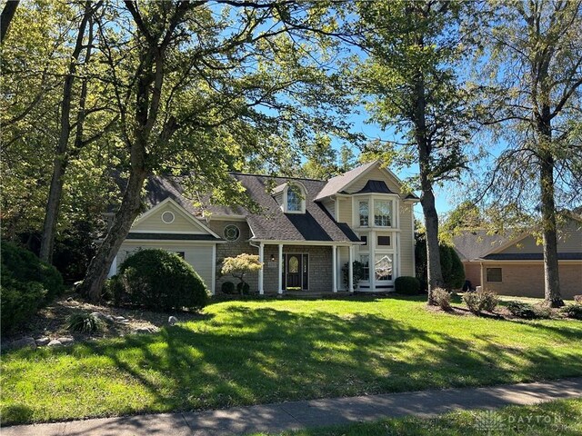 view of front of house with a front yard and a garage