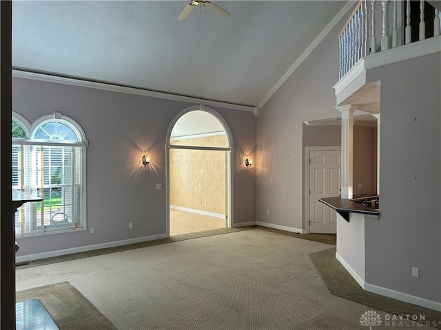 unfurnished living room featuring light carpet, ornamental molding, decorative columns, and ceiling fan