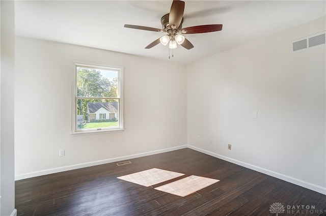 spare room with dark wood-type flooring and ceiling fan