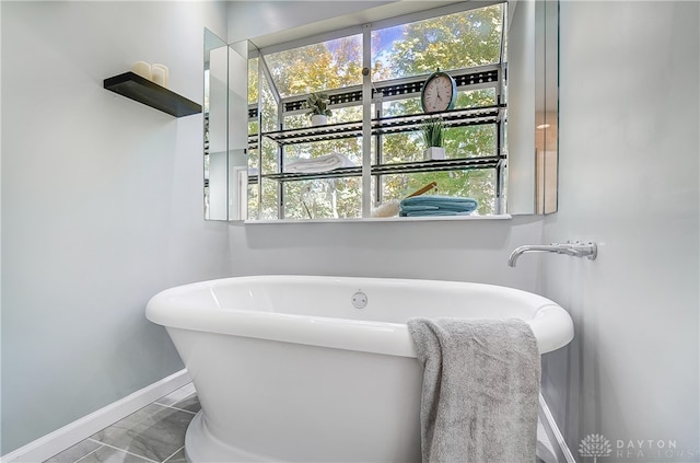 bathroom with a bathtub and tile patterned floors