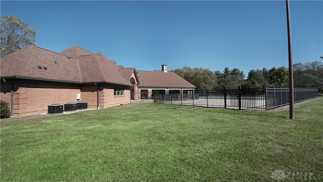 view of yard with central air condition unit and a swimming pool