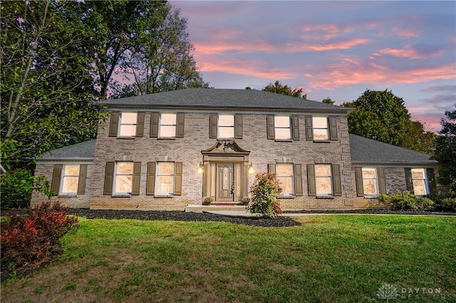 colonial home featuring a yard