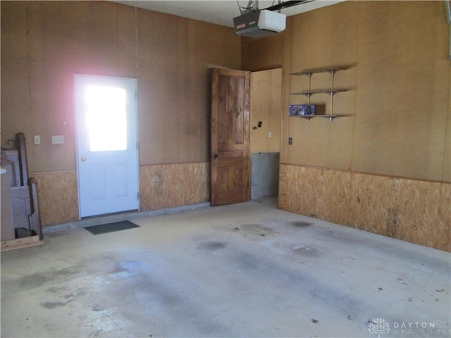204 N Main St, Lewisburg, OH 45338 - garage with a garage door opener and a wainscoted wall