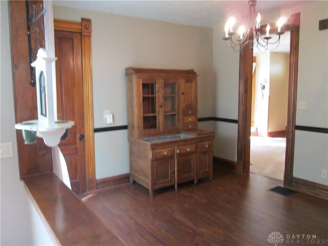 204 N Main St, Lewisburg, OH 45338 - dining area with a chandelier and dark wood-style flooring
