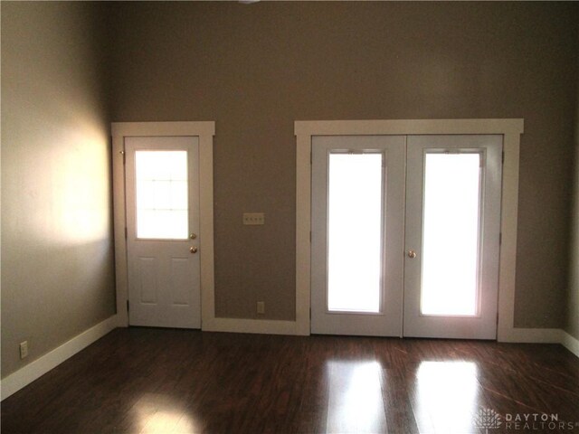 204 N Main St, Lewisburg, OH 45338 - doorway to outside featuring french doors, dark wood finished floors, and baseboards