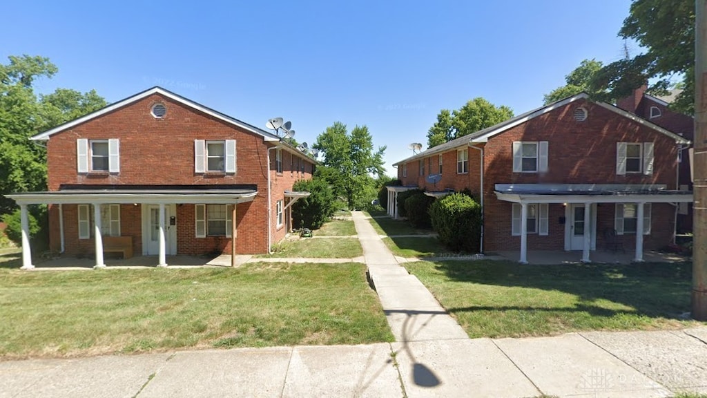 view of front property with a front yard and covered porch