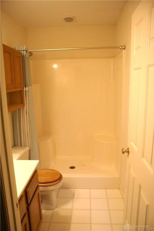 bathroom with vanity, toilet, and a shower