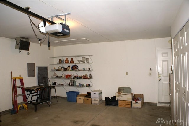 garage with a garage door opener and electric panel