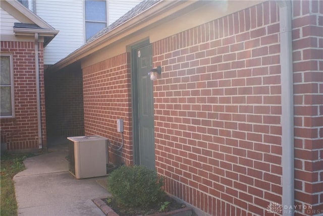 view of side of home with cooling unit and a patio area