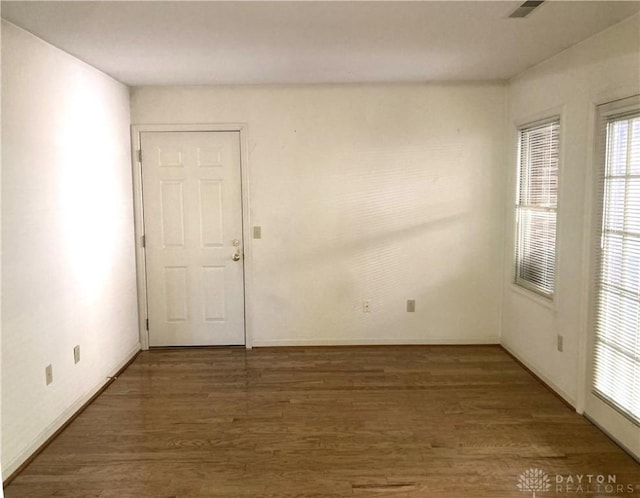 empty room featuring dark hardwood / wood-style flooring