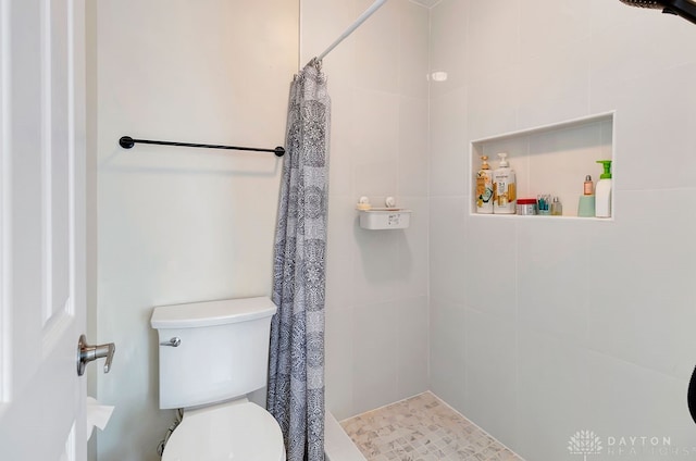 bathroom with toilet and curtained shower