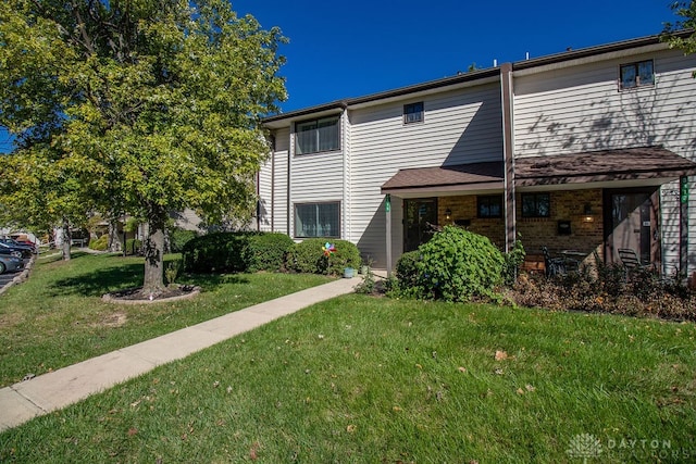 rear view of property with a yard