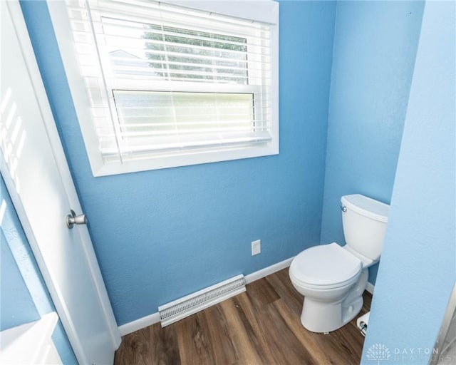 bathroom with toilet and hardwood / wood-style flooring