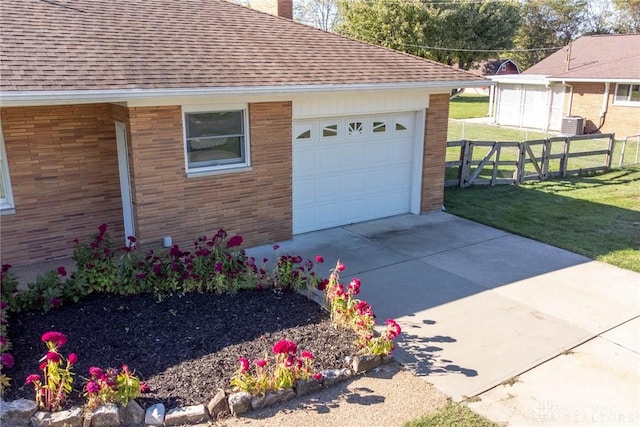 view of home's exterior with an outdoor structure, a garage, and a yard